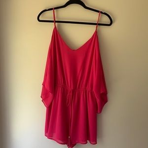 Hot pink dressy romper brand is Naked Zebra size large
